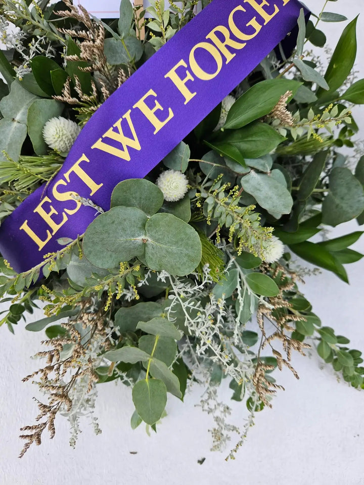 Lest We Forget wreath with eucalyptus, paper daisies, and native foliage for ANZAC remembrance